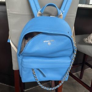 Michael Kors purse. Gold, removable, chain. 2 outside and 3 inside pockets.